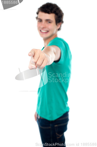 Image of Casual teen guy pointing at you