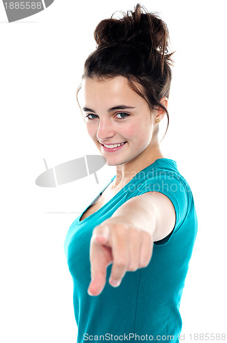 Image of Fashionable trendy girl pointing towards camera