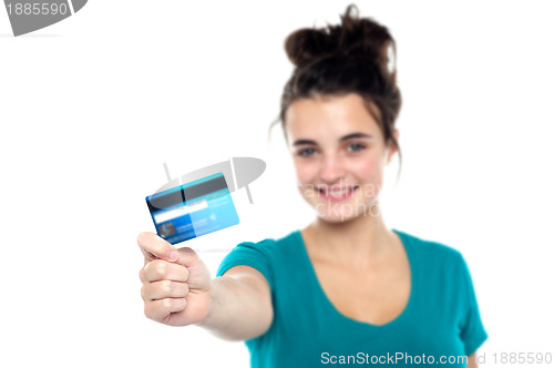 Image of Girl showing her cash card, arm stretched out
