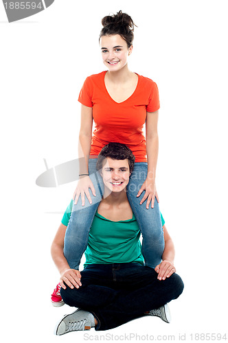 Image of Girl riding on her boyfriend's shoulder