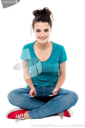 Image of Charming teenager posing with tablet pc in hands