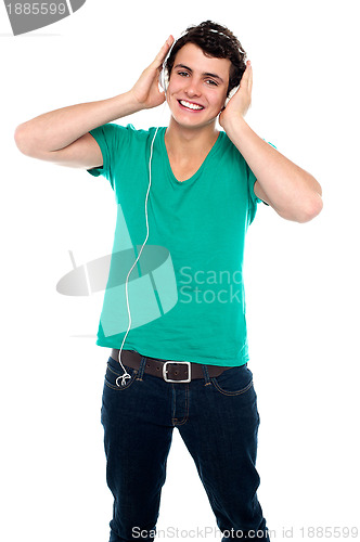 Image of Cheerful guy enjoying loud music