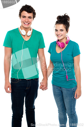 Image of Young couple with headphones around their necks