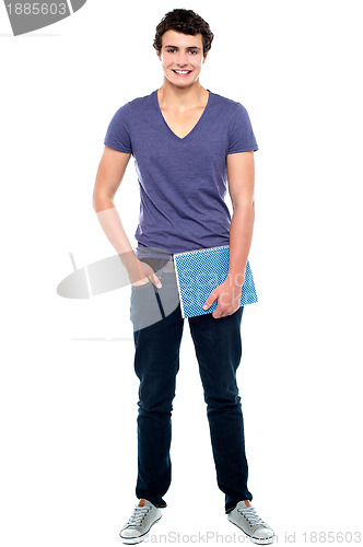 Image of Stylish college student posing with notebook in hand