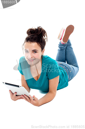 Image of Pretty teenager watching movie on tablet pc