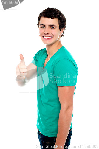 Image of Cheerful teenager showing thumbs up to camera