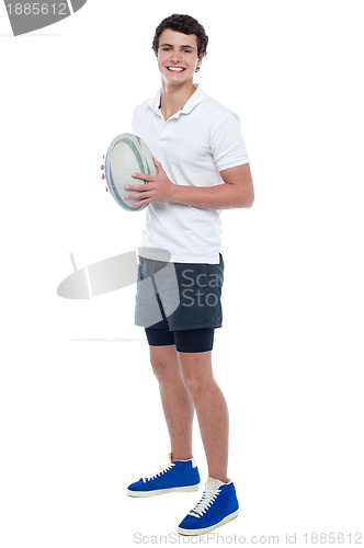 Image of Full length portrait of a rugby player holding ball
