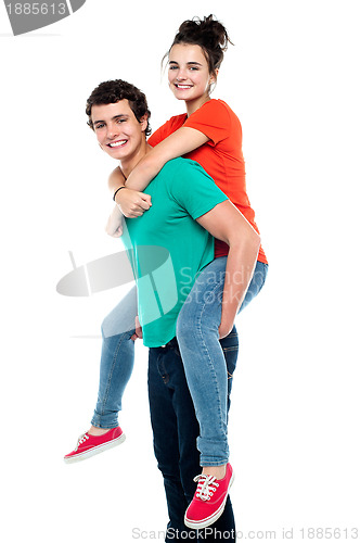 Image of Handsome young man giving a piggyback ride to his girlfriend