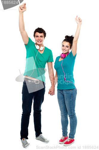 Image of Strong bonding of cheerful teen couple enjoying music