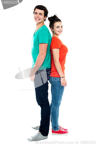 Image of Adorable young couple posing back to back