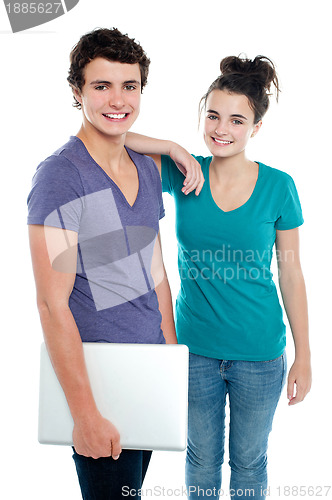 Image of Handsome guy holding laptop posing with his girlfriend