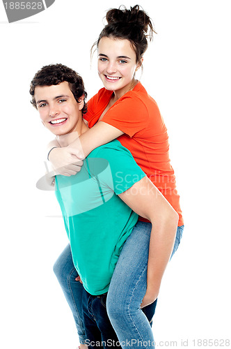 Image of Happy young girl enjoying piggyback ride on her boyfriend back