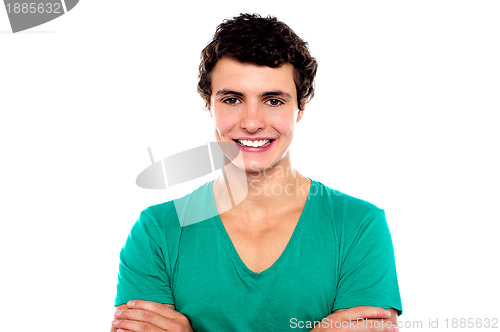 Image of Stylish trendy guy posing with folded arms