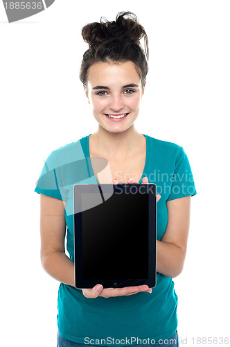 Image of Casual teenager showing newly launched tablet device