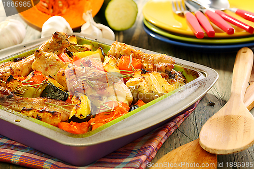 Image of Chicken baked with pumpkin, zucchini, celery and rosemary.