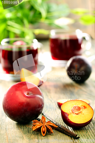 Image of Plums, spices and cups compote. 