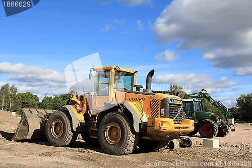 Image of One loader and grapple tractor at construction site