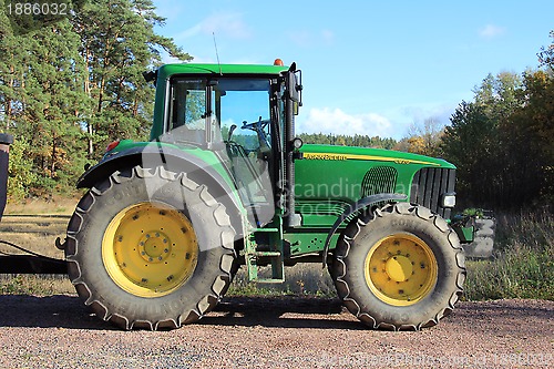 Image of Green tractor by field