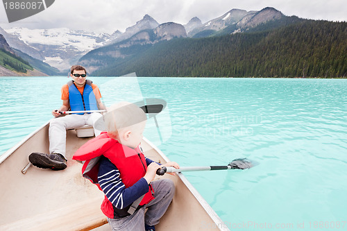 Image of father and son on a lake