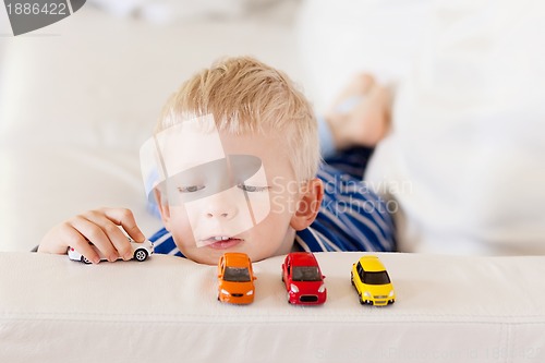 Image of toddler plays toy cars