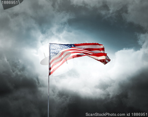 Image of American flag on a cloudy dramatic sky