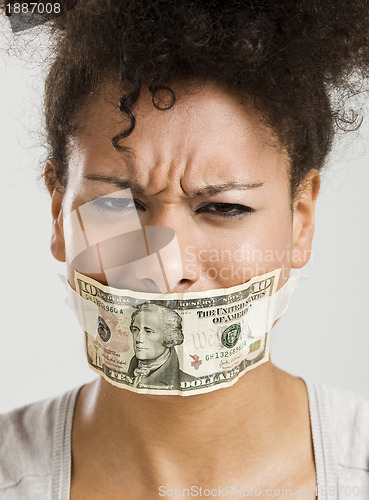 Image of Covering mouth with a dollar banknote