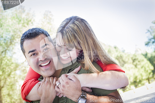 Image of Attractive Mixed Race Couple Piggyback at the Park