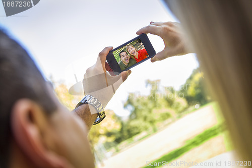 Image of Mixed Race Couple Taking Self Portrait at the Park