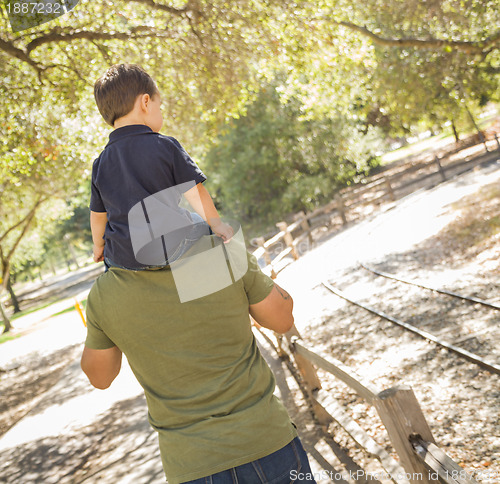 Image of Mixed Race Son Enjoy a Piggy Back in the Park with Dad