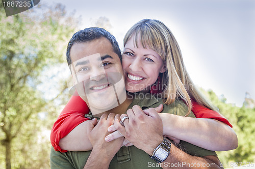 Image of Attractive Mixed Race Couple Piggyback at the Park