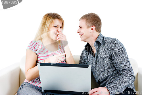 Image of young couple with a laptop on the background of isolation
