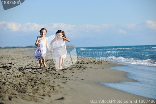 Image of cute little girls running on beach