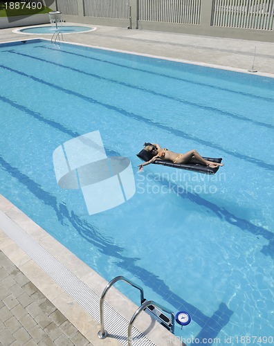 Image of beautiful woman relax on swimming pool