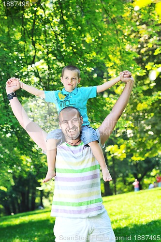 Image of happy father and son have fun at park