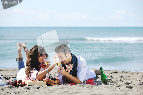 Image of young couple enjoying  picnic on the beach