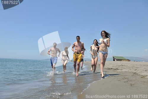 Image of happy people group have fun and running on beach