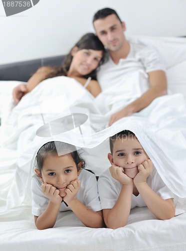 Image of happy young Family in their bedroom