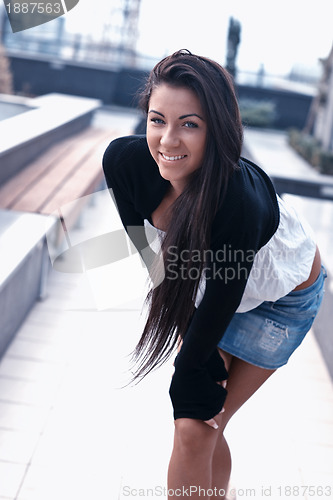 Image of beautiful young lady posing in garden