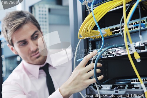 Image of young it engeneer in datacenter server room