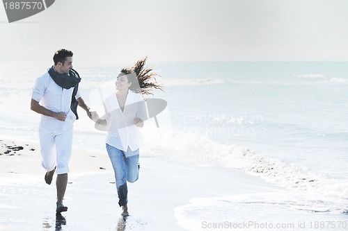 Image of happy young couple have fun at beautiful beach