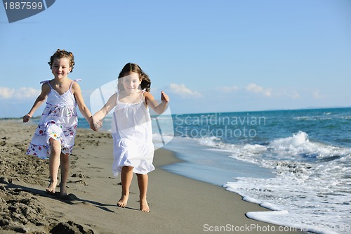 Image of cute little girls running on beach