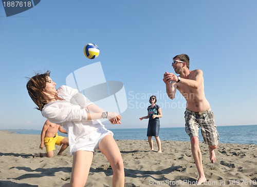 Image of young people group have fun and play beach volleyball