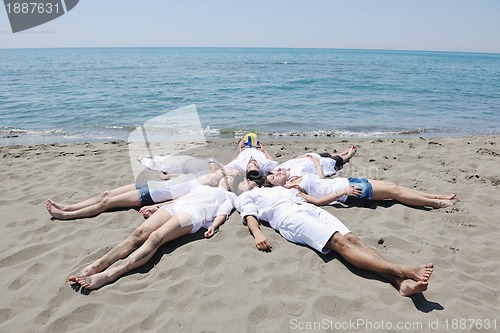 Image of Group of happy young people in have fun at beach