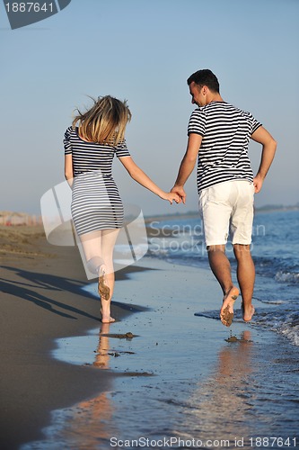 Image of happy young couple have romantic time on beach