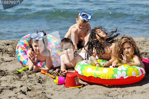 Image of child group have fun and play with beach toys