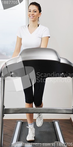 Image of womanworkout  in fitness club on running track machine 