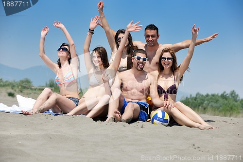 Image of happy child group playing  on beach