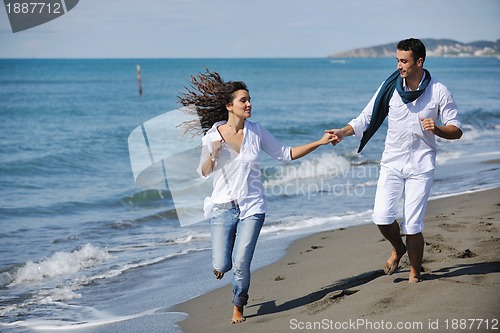 Image of happy young couple have fun at beautiful beach