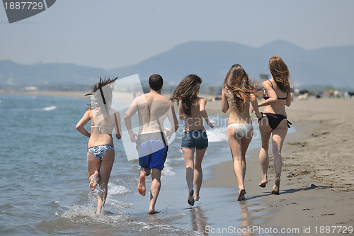 Image of happy people group have fun and running on beach