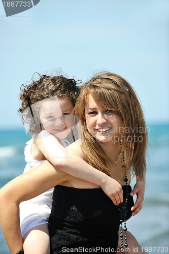Image of group portrait of childrens with teacher on beach